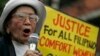 FILE - Anastacia Cortez, 92, who says she was held as a "comfort woman" by the Japanese military during World War II, speaks as members of the Lila Pilipina hold a rally at the Mendiola bridge, near the Malacanang Presidential palace in Manila, Philippi