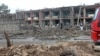 FILE - Afghan security personnel inspect the site of an attack on an army base in Gardez, capital of Paktia province, May 14, 2020.