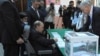 President Abdelaziz Bouteflika, sitting on a wheelchair, prepares to vote in the presidential elections in Algiers, Thursday, April 17, 2014.