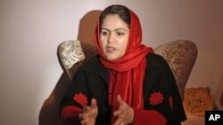 FILE - Former Afghan Parliamentarian Fawzia Koofi gestures during an interview in her office in Kabul, Afghanistan, March 3, 2014. 