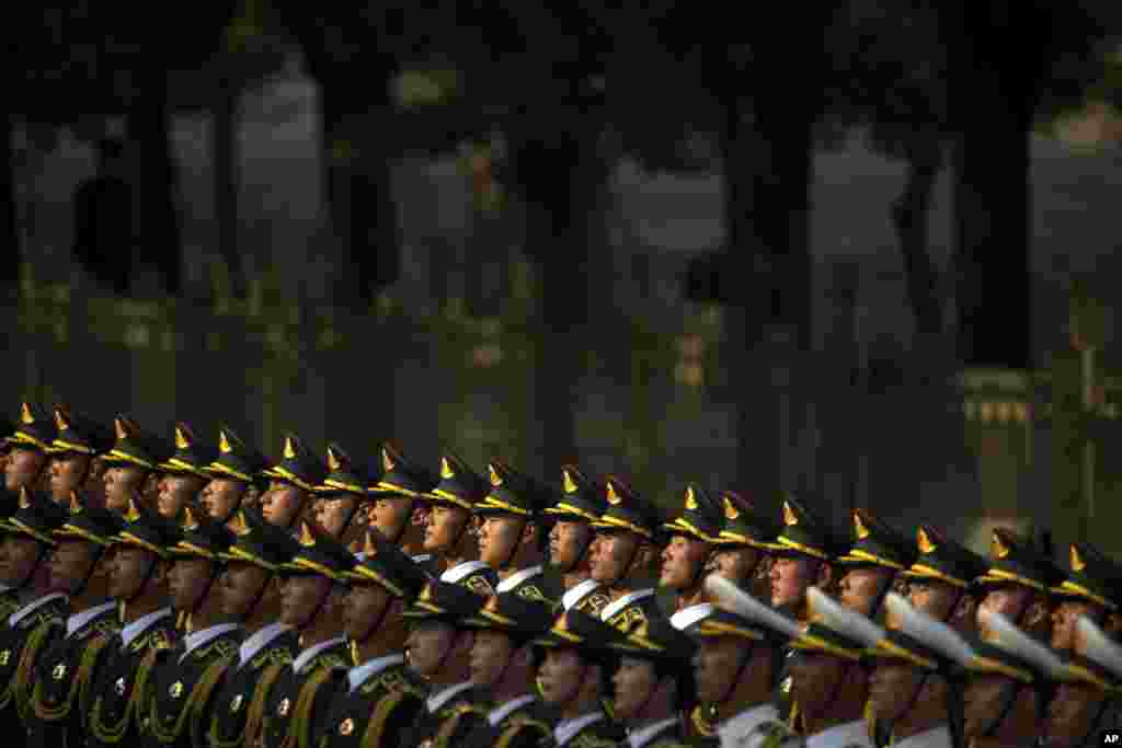 Members of the honor guard stand at attention during a welcoming ceremony for visiting Mozambique's President Filipe Jacinto Nyusi at the Great Hall of the People in Beijing, China.