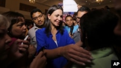 FILE - Venezuelan opposition politician Maria Corina Machado, shown greeting supporters after a news conference in Caracas, on July 15, 2015, says she's been barred from holding public office ahead of December's congressional election.