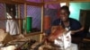 Restaurant owner, Bella Tandina, Dr. One Close, credits the success of his rotisserie to the superior quality of his cooking, his upbeat disposition, witty repartee with customers, which he calls his one-man marketing efforts, (Anne Look/VOA)