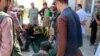 Relatives and others gather around the coffin of a soldier who died in heavy fighting between Afghan security and Taliban forces, outside a hospital in Takhar province, Oct. 21, 2020. A dozen children were killed in an airstrike a day later.