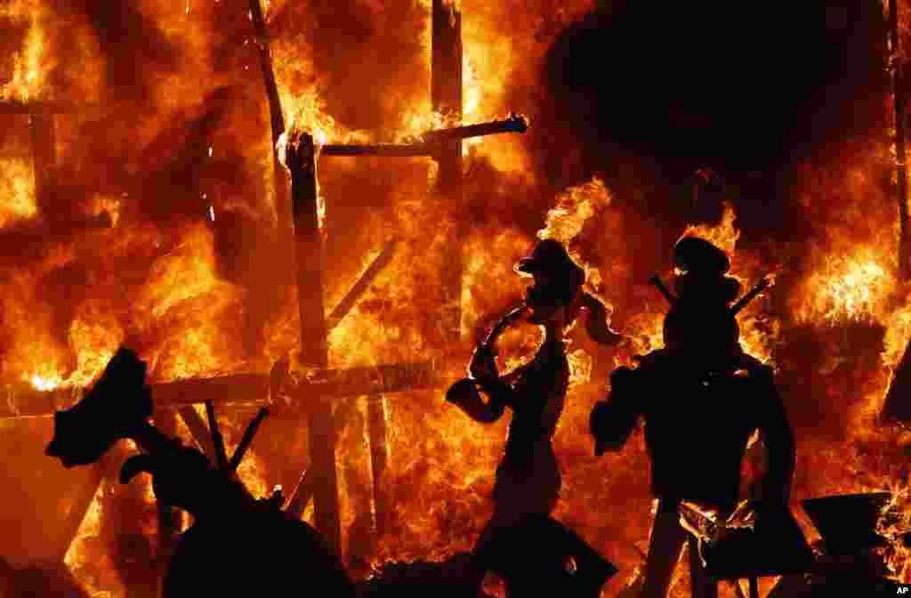 Beberapa patung tokoh-tokoh satir dibakar selama festival tradisional tahunan &#39;LaFallas&#39; di kota Valencia, Spanyol.