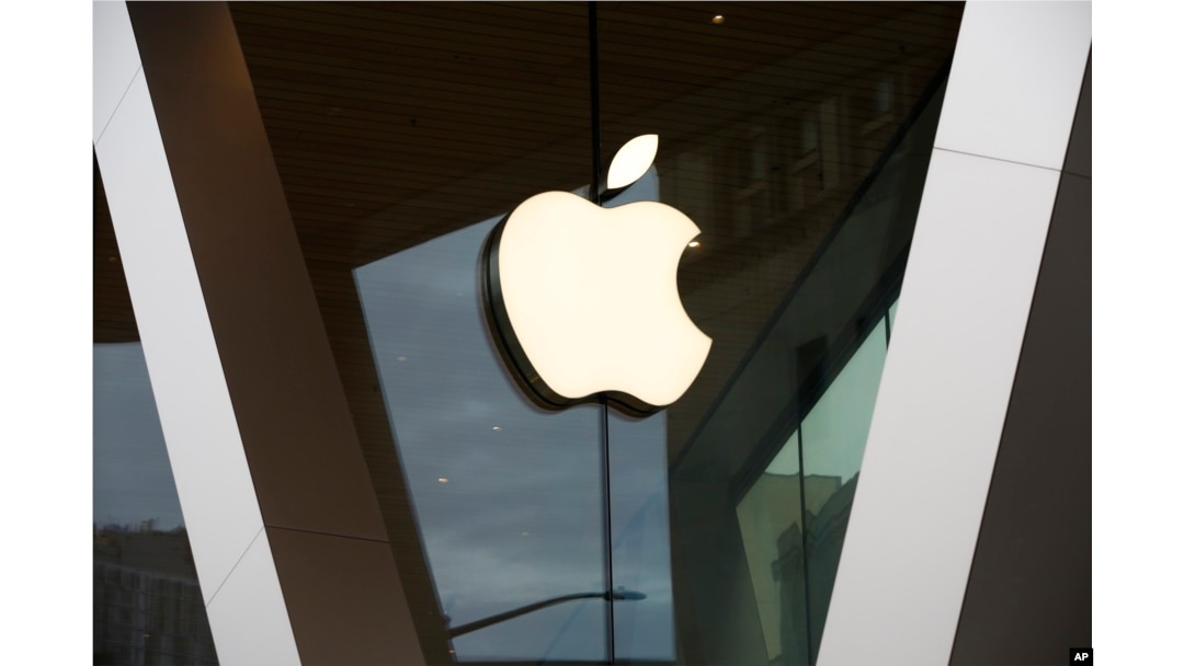 FILE - An Apple logo adorns the facade of the downtown Brooklyn Apple store in New York, Saturday, March 14, 2020. (AP Photo/Kathy Willens, File)
