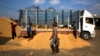 FILE - Thai workers unload rice from the truck of a farmer, at a rice collection center, in the northeastern province of Roi Et, in Thailand. 