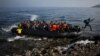 An Afghan migrant jumps off an overcrowded raft onto a beach in the island of Lesbos, Greece, Oct. 19, 2015.