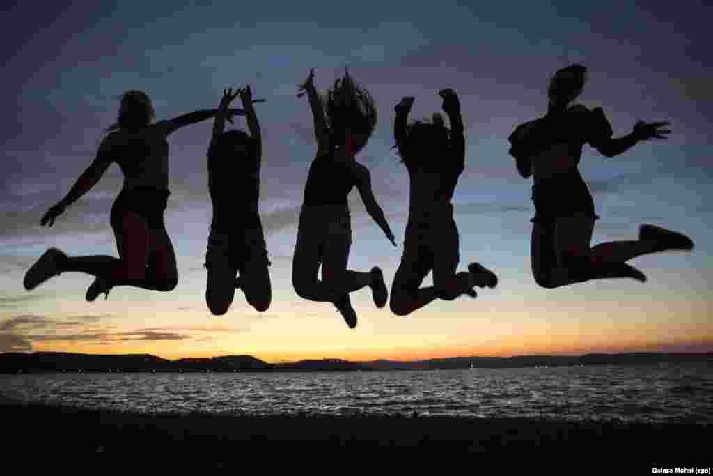 Revelers jump in the air on the shore of Lake Balaton during the opening of Balaton Sound music festival in Zamardi, 110 km southwest of Budapest, Hungary, July 6, 2016.