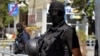 FILE - Kosovo police officers stand guard outside a Pristina courthouse in 2014 following the arrest of 40 men suspected of having fought with Islamist insurgents in Syria and Iraq.