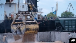 ARCHIVES-Des ouvriers chargent des céréales sur un navire dans un port céréalier d'Izmail, en Ukraine, le 26 avril 2023.