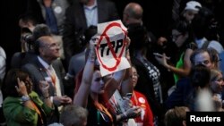 A delegate holds an anti-Trans-Pacific Partnership (TPP) trade agreement sign during the first day of the Democratic National Convention in Philadelphia, July 25, 2016. 