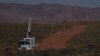 A crew with the Navajo Tribal Utility Authority installs power poles, Oct. 9, 2024, on the Navajo Nation in Halchita, Utah. 