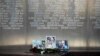 Flowers are placed by portraits of slain journalists Alexander Rastorguyev, Kirill Radchenko and Orkhan Dzhemal, at the Russian journalists Union building in Moscow, Russia, Wednesday, Aug. 1, 2018. 