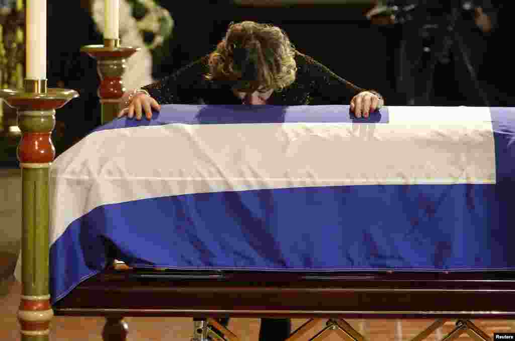 Renata Ford, the widow of former Toronto mayor Rob Ford who died last week of cancer, kisses his coffin during his funeral at St. James Cathedral in Toronto, Canada.