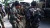 Philippine National Police (PNP) carry a body bag, containing a member of the Special Action Force, to a van in Mamasapano town, Maguindanao province, January 26, 2015.