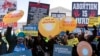 Kelompok pro dan anti aborsi sama-sama melakukan aksi unjuk rasa di luar gedung Mahkamah Agung AS di Washington DC, Rabu (1/12). 
