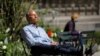 A person sits in Bryant Park after the Centers for Disease Control and Prevention announced new guidelines regarding outdoor mask-wearing and vaccination during the outbreak of the coronavirus, in Manhattan, New York City, New York, April 27, 2021.