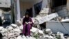 Artist Saja Moussa draws on broken tiles from her family's house in Rafah refugee camp, southern Gaza Strip, June 15, 2021.