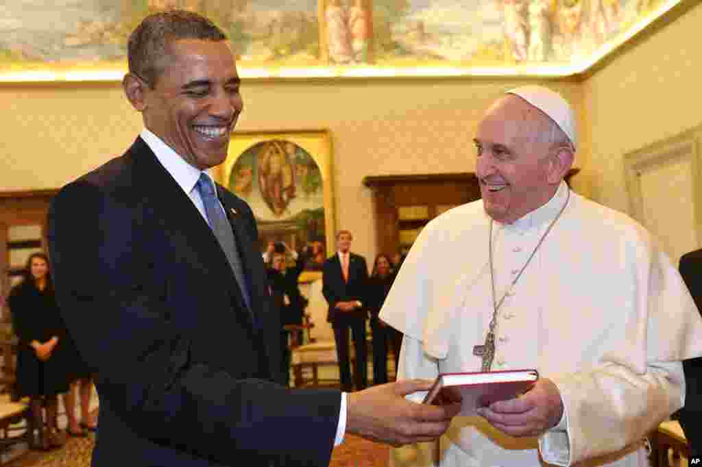 Paus Fransiskus (kanan) dan Presiden AS Barack Obama bertukar cendera mata dalam pertemuan di Vatikan.