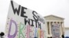 FILE - Demonstrators rally outside the Supreme Court as justices were scheduled to hear arguments in the consolidation of three cases regarding the Trump administration’s bid to end DACA, in Washington, Nov. 12, 2019.
