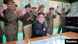 North Korean leader Kim Jong Un reacts during a test launch of ground-to-ground medium long-range ballistic rocket Hwasong-10 in this undated photo released by North Korea's Korean Central News Agency (KCNA) on June 23, 2016. 
