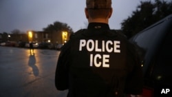 FILE - U.S. Immigration and Customs Enforcement (ICE) agents are seen in Dallas, Texas, March 6, 2015.