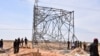 Nigerian security forces are seen on the site of a sabotage attack allegedly perpetrated by Boko Haram against electical infrastructures on the outskirts of Maiduguri on Feb. 12, 2021.