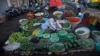 A roadside vendor arranges vegetables at his shop early in the morning in Ahmadabad, India, Dec. 29, 2015. 