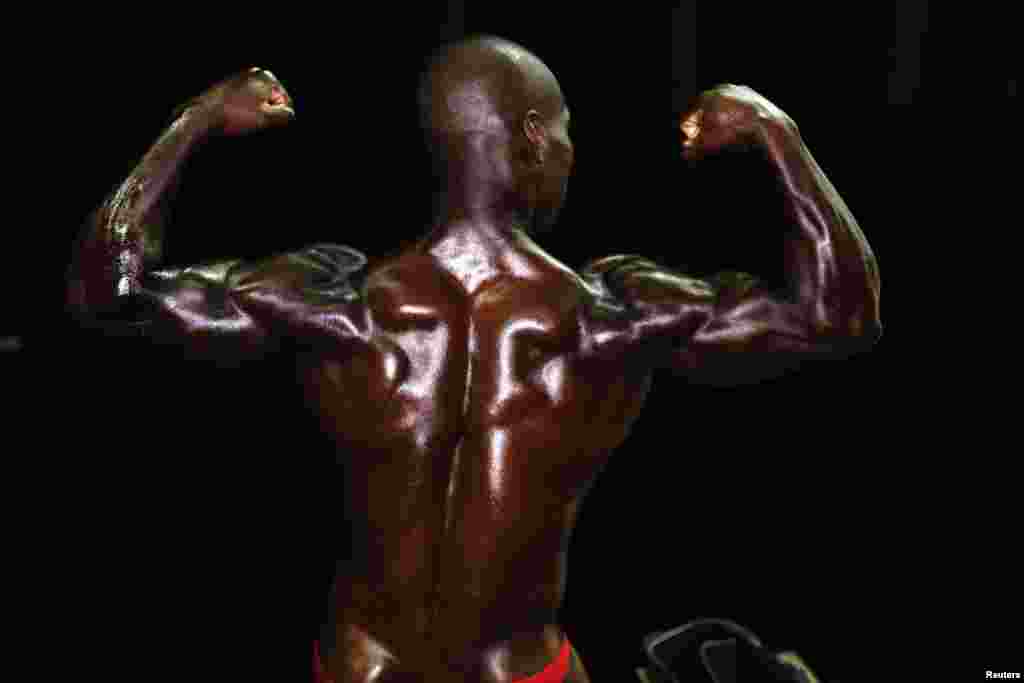 A bodybuilder strikes a pose backstage during an amateur competition in the Israeli city of Dimona, April 3, 2014.