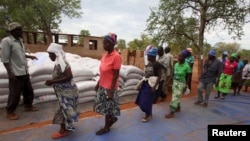 FILE: Villagers collect their monthly food ration provided by the United Nations World Food Program (WFP) in Masvingo, Zimbabwe.