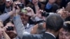 Members of the audience take photographs as President Barack Obama shakes hands at The National Association of Latino Elected and Appointed Officials’ Annual Conference at the Walt Disney World Resort in Florida, June 22, 2012.