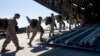 FILE - U.S. Marines are seen boarding a military transport plane.