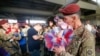 FILE - Sean Smith, a paratrooper with the 1st Brigade Combat Team, 82nd Airborne Division, kisses his daughter Olivia Rose Smith, 10 months, after returning home from Afghanistan at Pope Army Airfield in Fort Bragg, North Carolina, Nov. 5, 2014.