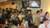 Police officers inside the Foreign Correspondents Club to deliver letters to human rights panelists.