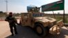 Iraqi army members stand guard at the entrance to the Nineveh Liberation Operations Command at Makhmour base, south of Mosul, Iraq, March 13, 2016.
