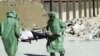 FILE - People in protective suits and gas masks conduct a drill on how to treat casualties of a chemical weapons attack in Aleppo, Syria. Islamic State fighters reportedly fired rockets loaded with mustard gas into a town north of Baghdad late Tuesday and early Wednesday. 
