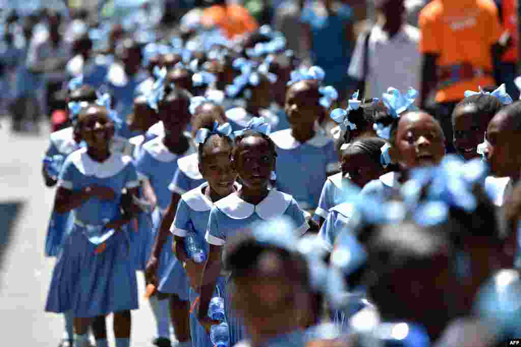 Haitian students walk as they head to a security zone during an Earthquake and Tsunami Emergency drill in the city of Cap-Haitien. An estimated 4,500 people participated in the activities during the exercise.