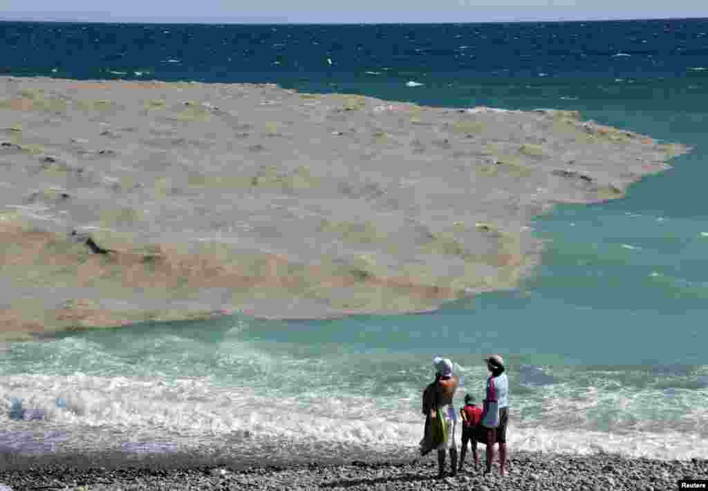 Beberapa wisatawan menikmati pantai di kota Nice, Perancis setelah pemerintah setempat untuk sementara melarang berenang pasca badai dahsyat melanda Nice.