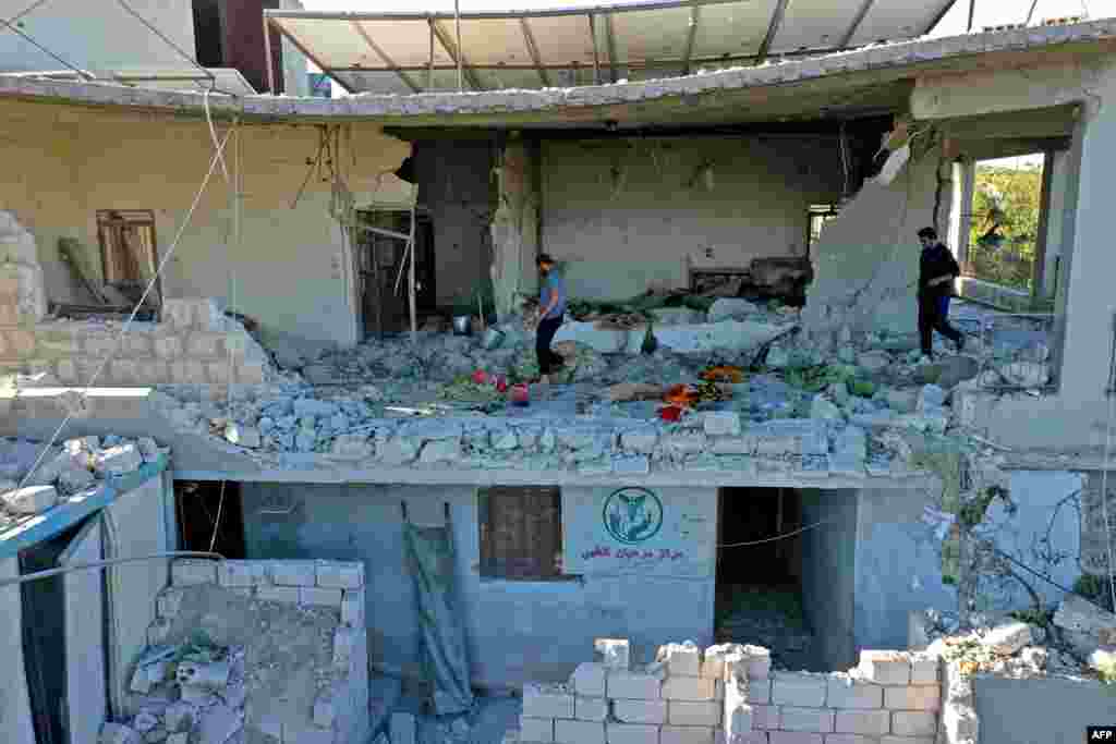 A building sheltering the only medical center in Syria's northwestern Jabal az-Zawiya region is seen after being struck by pre-dawn shelling.