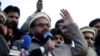 FILE - Hafiz Saeed, chief of Pakistani religious group Jamaat-ud-Dawa, addresses a rally for Kashmir Day in Lahore, Pakistan, Feb. 5, 2019.