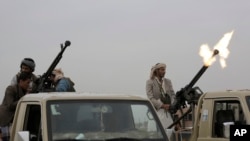 FILE - A Houthi rebel fires into the air during a gathering aimed at mobilizing more fighters for the movement, in Sanaa, Yemen, Aug. 1, 2019. The Yemen conflict began with the 2014 takeover of Sanaa by the Houthis.