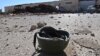 A helmet belonging to an Islamic State militant is seen on the ground at the 121 Regiment base after Fighters from the Democratic Forces of Syria took control of the base in the town of al-Melabiyyah, south of Hasaka city, Syria, Nov. 24, 2015.