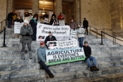 Farmers and other supporters hold signs Jan. 13, 2020, at the Capitol in Olympia, Wash., during a day to raise awareness of issues facing farmers in Washington state on the first day of the 2020 session of the Washington legislature.