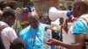 Health workers teach people about the Ebola virus and how to prevent infection, in Conakry, Guinea, Monday, March 31, 2014. (AP Photo/ Youssouf Bah)
