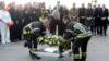 Belgium's King Philippe, center, and firefighters lay a wreath in front of the damaged Zaventem Airport terminal in Brussels on March 23, 2016. 