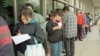 FILE - A line forms outside the Immigration and Naturalization Service office in Los Angeles, March 20, 1996.