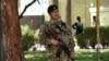 An Afghan policeman stands guard in the courtyard of the police headquarters in Kabul, Oct. 12, 2020.