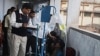 FILE - A doctor tends to alcohol poisoning patients who drank bootleg alcohol in this Dec. 15, 2011, photo. Each year, hundreds of people die in India because of illegal alcohol.