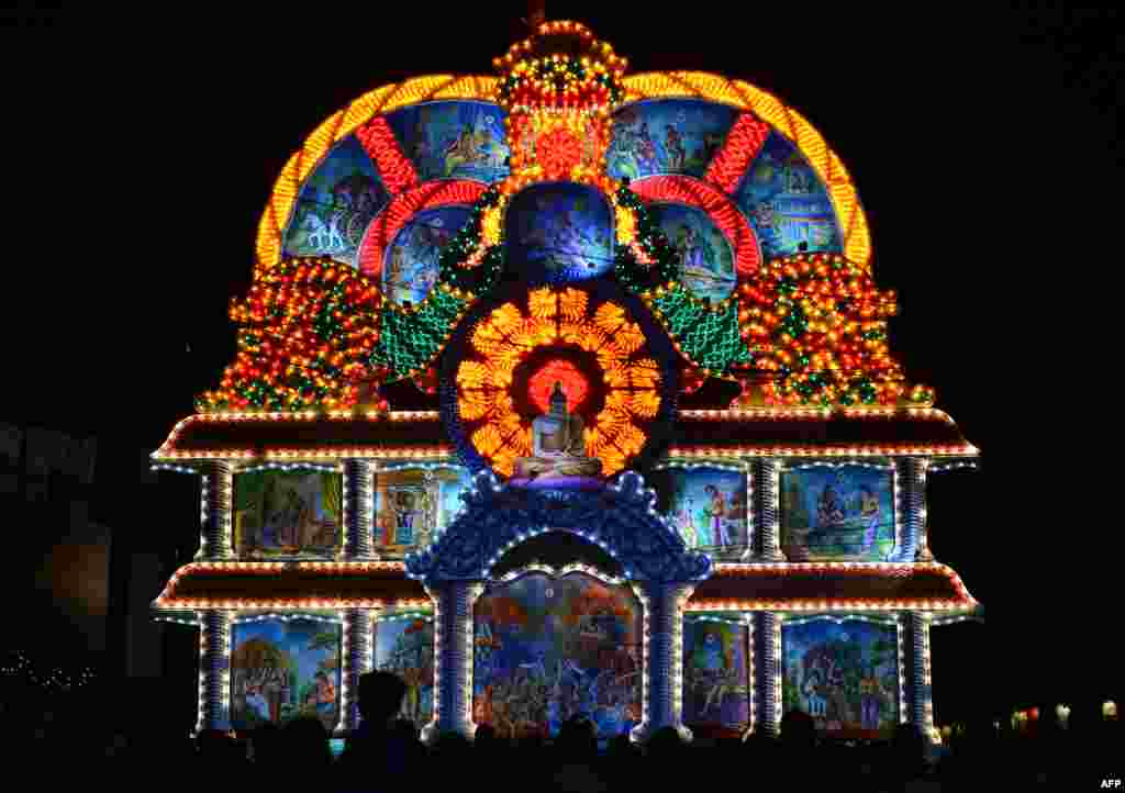 A giant display features a seated Buddha during the annual Vesak Buddhist Festival celebrations in Colombo, Sri Lanka.